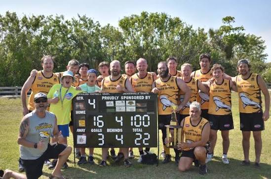 Tiger Sharks team with scoreboard